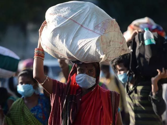 stranded migrant labourers walk carrying their belongings to board a special train photo afp stranded migrant labourers walk carrying their belongings to board a special train photo afp