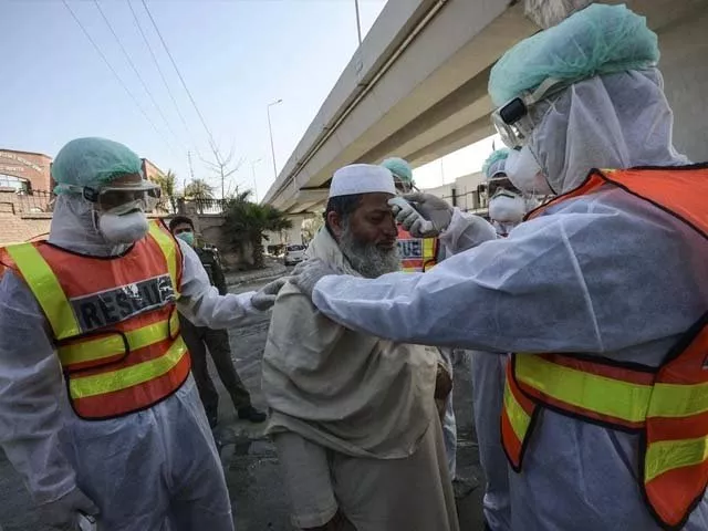 pakistani rescue personnels check the body temperature of a man during a drill photo afp pakistani rescue personnels check the body temperature of a man during a drill photo afp