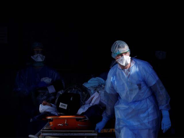 a coronavirus patient being carried on a stretcher photo reuters
