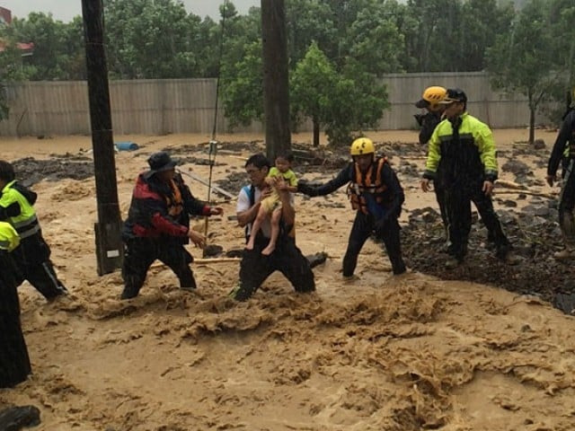 this handout picture taken on august 8 2015 and released on august 9 2015 by the new taipei city fire department shows rescue personnel moving an 8 year old girl to safety in wulai new taipei city as typhoon soudelor hit taiwan photo afp this handout picture taken on august 8 2015 and released on august 9 2015 by the new taipei city fire department shows rescue personnel moving an 8 year old girl to safety in wulai new taipei city as typhoon soudelor hit taiwan photo afp