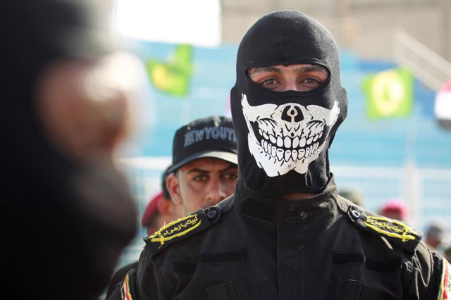 fighters from the iraqi imam ali brigade take part in a military parade on august 8 2015 in the mostly shia holy city of najaf photo afp