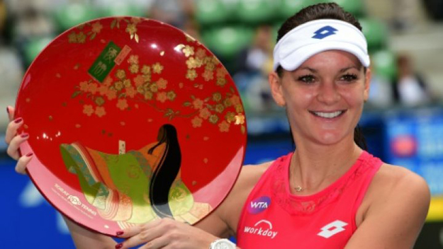 agnieszka radwanska of poland holds the championship trophy after beating belinda bencic of switzerland in the women 039 s singles final of the pan pacific open in tokyo on september 27 2015 photo afp