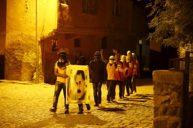 masked members of ydg h youth wing of the outlawed kurdistan workers party pkk shout slogans as they hold a portrait of pkk 039 s jailed leader abdullah ocalan in diyarbakir turkey on september 1 2015 photo reuters