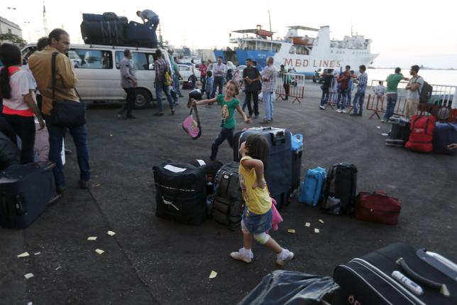 syrian girls play around suitcases as they wait at lebanon 039 s northern tripoli port for a passenger ferry to turkey september 22 2015 photo reuters