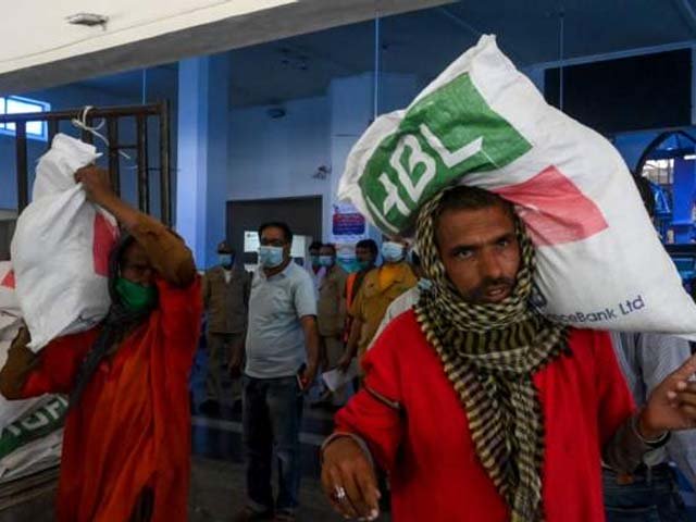 porters get free essential food items at the lahore railway station photo afp