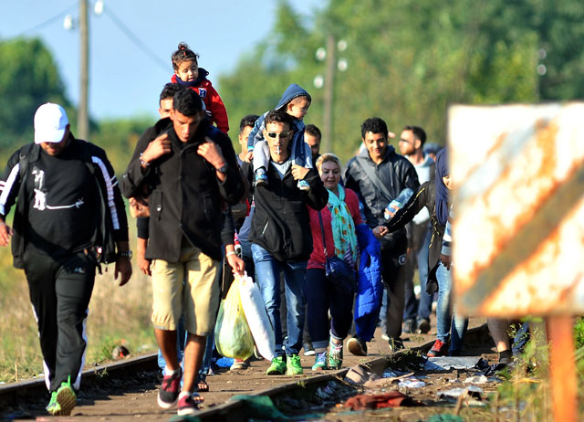 refugees from middle eastern countries walk on railway tracks to the hungarian border near the northern serbia 039 s town of horgos on september 14 2015 before hungary seals its border on september 15 photo afp