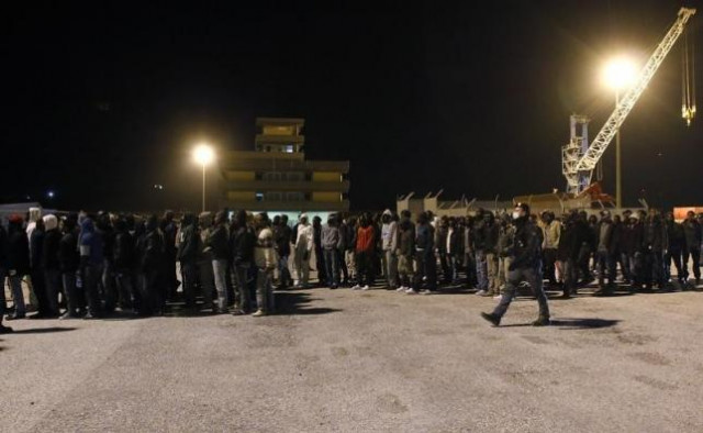 police escort migrants as they are disembarked from a navy ship in the sicilian harbour of augusta march 4 2015 photo reuters police escort migrants as they are disembarked from a navy ship in the sicilian harbour of augusta march 4 2015 photo reuters