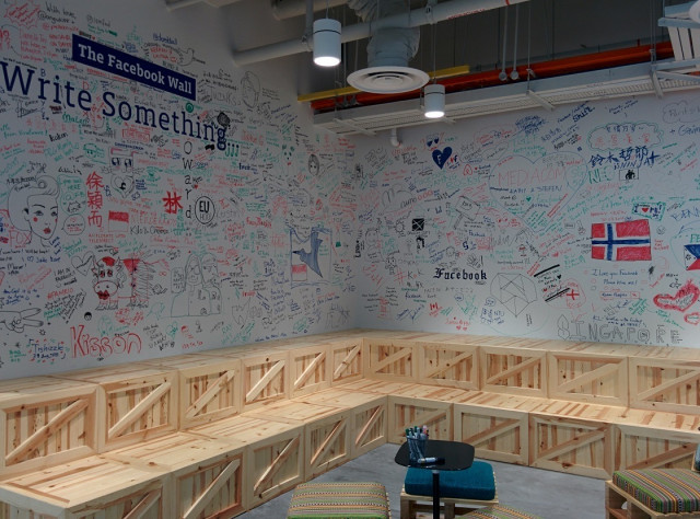 visitors to the office are greeted by the facebook wall where they can leave their own message for posterity photo tech in asia visitors to the office are greeted by the facebook wall where they can leave their own message for posterity photo tech in asia