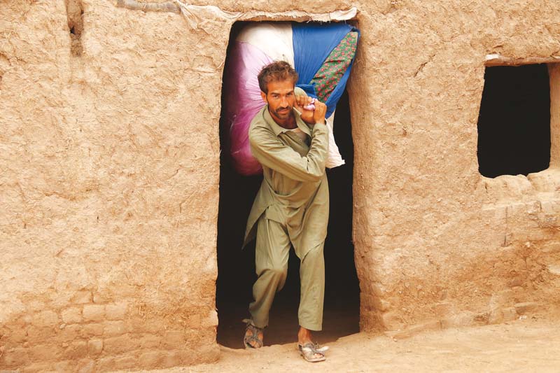 an afghan refugee vacates his temporary residence at ghondai camp tehkal payan photo muhammad iqbal