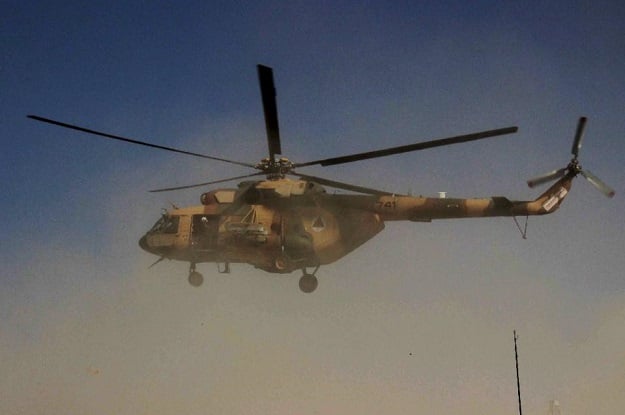 an afghan helicopter carrying security personnel arrives at the scene of an operation against taliban insurgents in kunduz on september 30 2015 photo afp