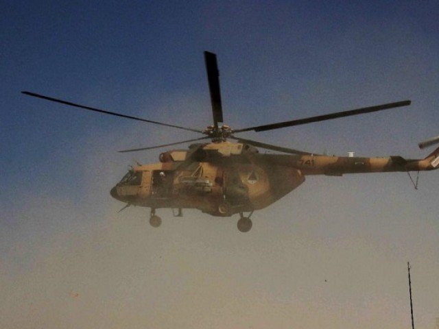 an afghan helicopter carrying security personnel arrives at the scene of an operation against taliban insurgents in kunduz on september 30 2015 photo afp
