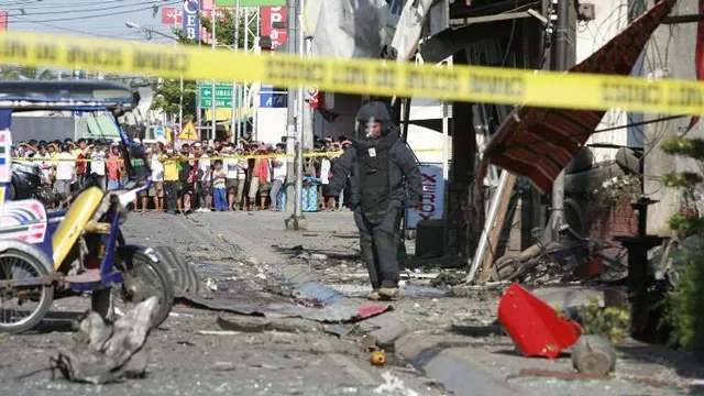 a bomb disposal officer walks among the wreckage after a bomb exploded outside a bus station in zamboanga southern philippines on jan 23 2015 photo afp a bomb disposal officer walks among the wreckage after a bomb exploded outside a bus station in zamboanga southern philippines on jan 23 2015 photo afp