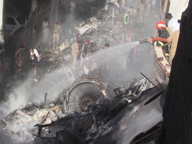 rescue workers gather at the site after a pia plane crashed photo afp rescue workers gather at the site after a pia plane crashed photo afp