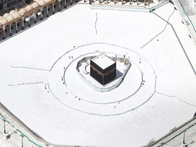 a few workers are seen nearby an empty kaaba after the precautions against the novel coronavirus photo afp