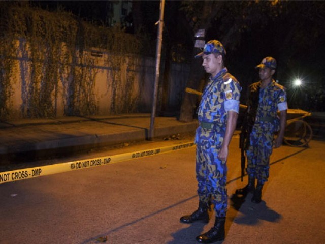 bangladeshi police officers stand guard on september 28 2015 at the site where an italian charity worker has died after being shot by attackers in dhaka photo afp