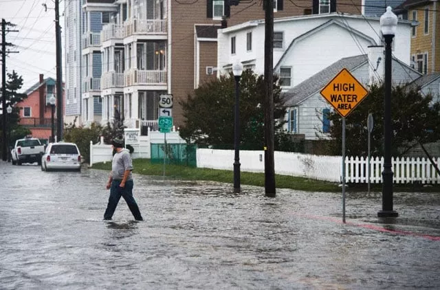 a man crosses a flooded street in ocean city maryland on october 3 2015 as coastal flooding warnings are issued along the us east coast as heavy rains partly fueled by hurricane joaquin continue to fall on the area photo afp a man crosses a flooded street in ocean city maryland on october 3 2015 as coastal flooding warnings are issued along the us east coast as heavy rains partly fueled by hurricane joaquin continue to fall on the area photo afp