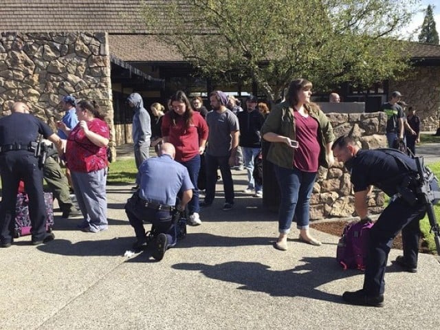 police officers inspect bags as students and staff are evacuated from campus following a shooting incident at umpqua community college in roseburg oregon october 1 2015 photo reuters