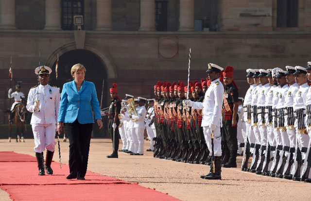 german chancellor angela merkel inspects the guard of honour during a ceremonial reception at the presidential palace in new delhi on october 5 2015 photo afp