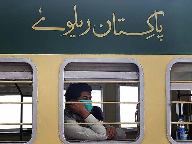 pakistani people wearing a face mask as a precaution against coronavirus at rawalpindi railway station photo afp