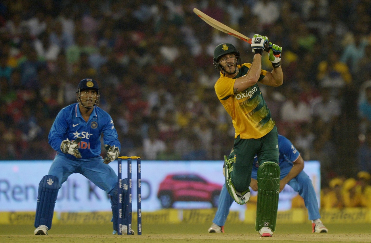 south africa 039 s captain faf du plessis r plays a shot as india 039 s captain mahendra singh dhoni looks on during the second t20 cricket match between india and south africa at the barabati stadium in cuttack on october 5 2015 photo afp