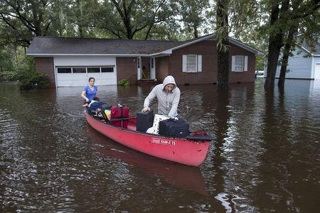 greg rodermond r and mandy barnhill use a canoe to evacuate from mandy 039 s home on long avenue in conway south carolina on october 5 2015 photo reuters