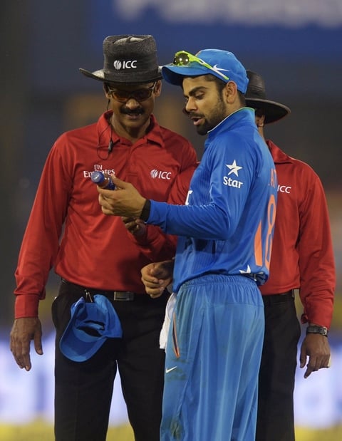 india 039 s virat kohli c shows a bottle thrown in the ground to the umpires as play is interrupted by spectators throwing bottles onto the pitch during the second t20 cricket match between india and south africa at the barabati stadium in cuttack photo afp