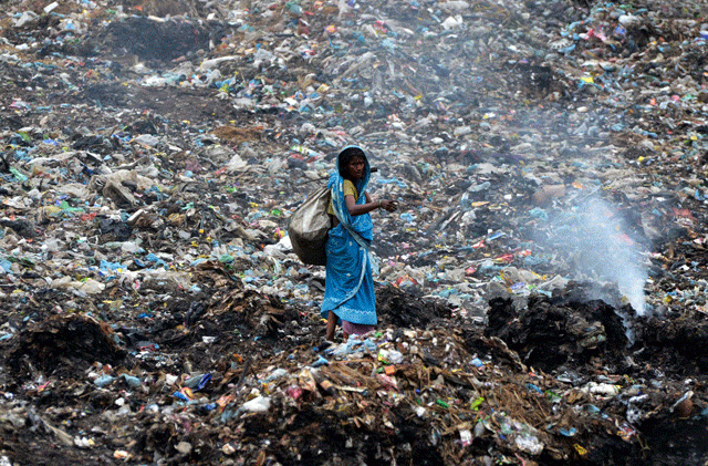 an indian ragpicker walks among heaps of rubbish at a municipal waste dump in dimapur on world earth day photo afp an indian ragpicker walks among heaps of rubbish at a municipal waste dump in dimapur on world earth day photo afp