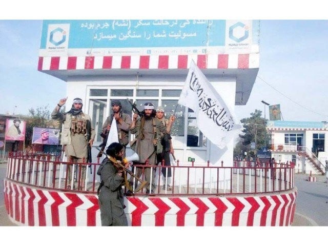 a picture shared by the afghan taliban spokesperson on twitter purportedly shows insurgents carrying flags in kunduz city