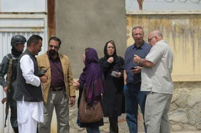 foreign nationals talk with afghan security personnel at the gate of the cure international hospital in kabul after a gunman killed three american photo afp foreign nationals talk with afghan security personnel at the gate of the cure international hospital in kabul after a gunman killed three american photo afp