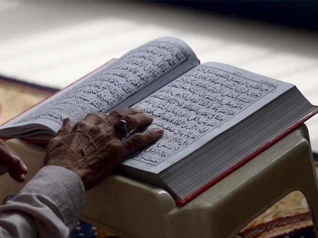 a pakistani muslim devotee recites the quran photo afp