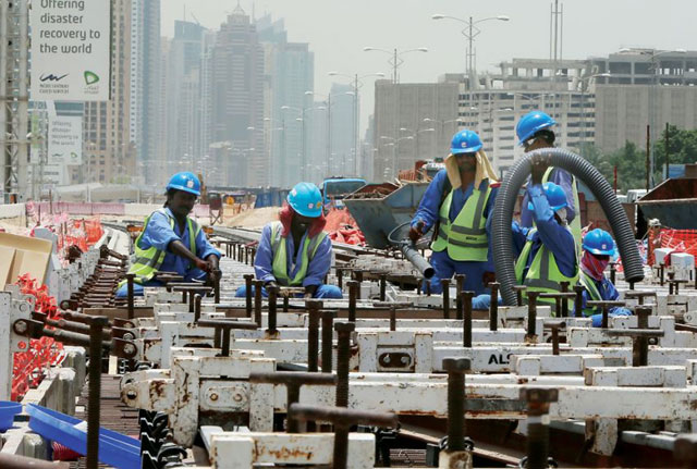 asian labourers work at the construction site of a track for the dubai metro photo afp