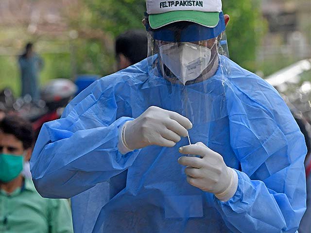 a health official wearing protective gear holds a coronavirus sample photo afp