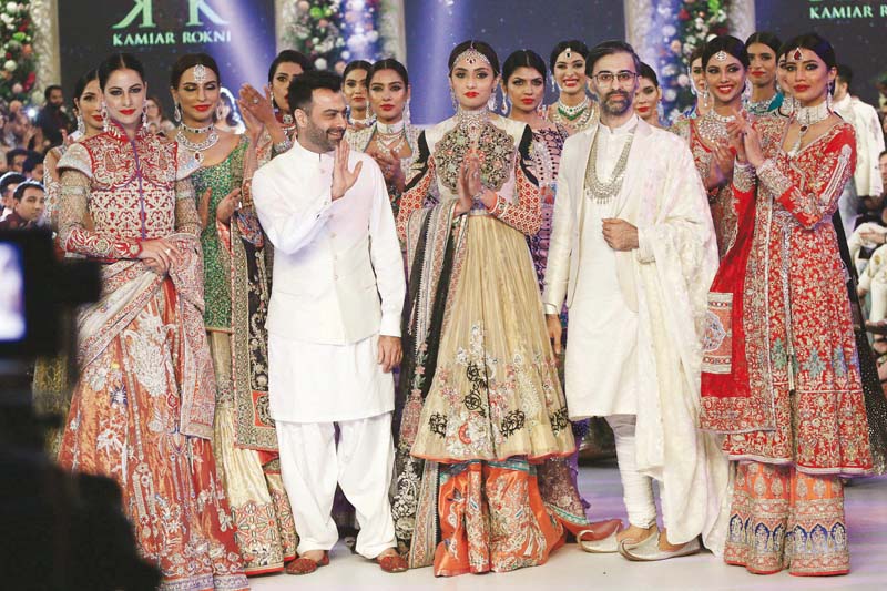 rokni and bashir stand amid models sporting their alchemy collection at plbw 2015 photo shafiq malik express