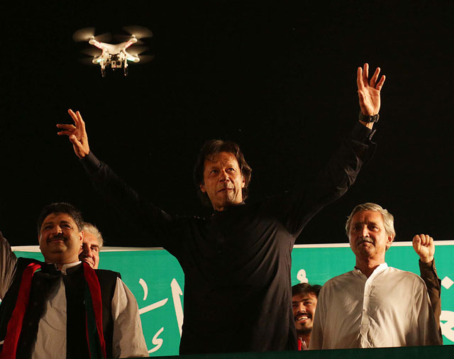 pti chairman imran khan waves to his supporters upon arrival at muzang chowngi in lahore on october 9 2015 photo express shafiq malik