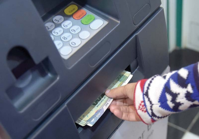a customer withdraws cash from atm photo file a customer withdraws cash from atm photo file
