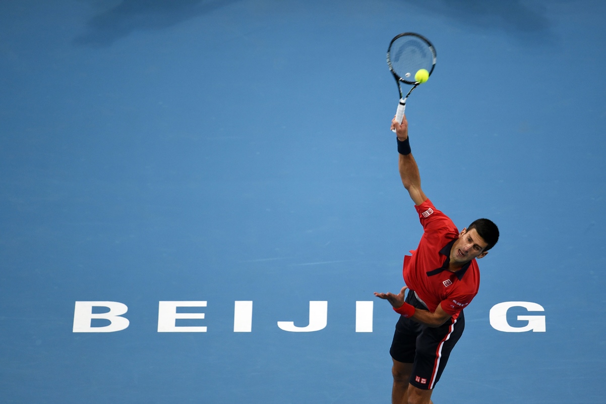 novak djokovic of serbia serves to david ferrer of spain during their men 039 s singles semi final match at the china open tennis tournament in beijing on october 10 2015 photo afp