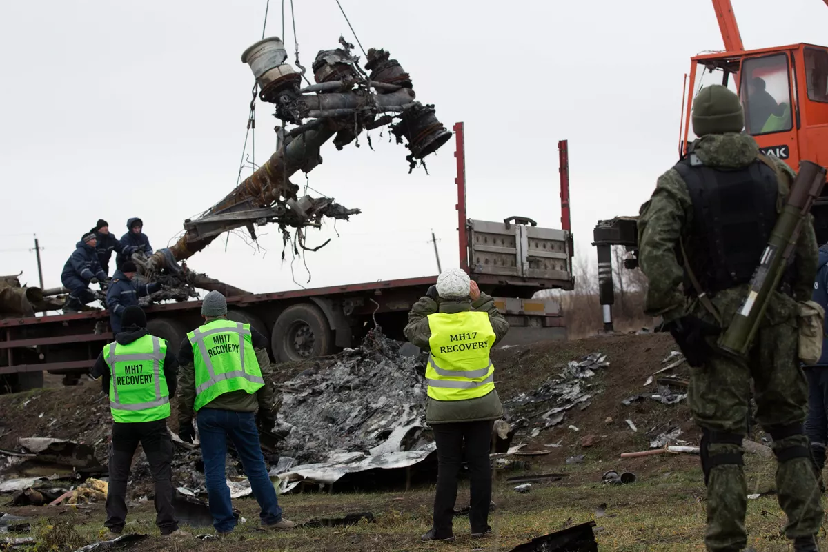 members of the dutch export team watch as parts of the wreckage of the malaysia airlines flight mh17 are removed and loaded on a truck at the crash site near the village of grabove in eastern ukraine on november 16 2014 photo afp members of the dutch export team watch as parts of the wreckage of the malaysia airlines flight mh17 are removed and loaded on a truck at the crash site near the village of grabove in eastern ukraine on november 16 2014 photo afp