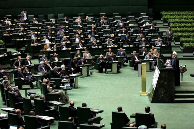 iranian president hassan rouhani r delivers a speech to parliament before presenting the proposed annual budget in tehran on december 7 2014 photo afp