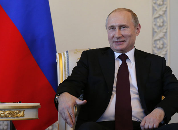 russian president vladimir putin smiles as he attends a meeting with his kyrgyz counterpart in saint petersburg on march 16 2015 photo afp