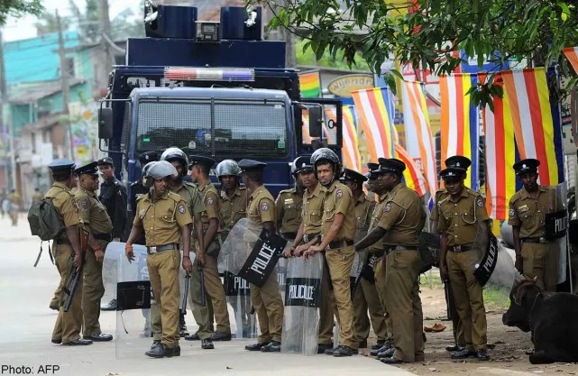 sri lankan police stand guard by a roadside following clashes between muslims and an extremist buddhist group in the town of alutgama on june 16 2014 photo afp sri lankan police stand guard by a roadside following clashes between muslims and an extremist buddhist group in the town of alutgama on june 16 2014 photo afp