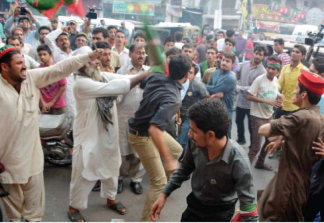 party workers quarrel with a policeman in garhi shahu photo abid nawaz express party workers quarrel with a policeman in garhi shahu photo abid nawaz express