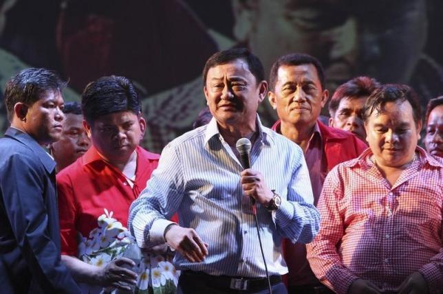 former thai prime minister thaksin shinawatra c addresses his supporters during a ceremony in siem reap province cambodia april 14 2012 photo reuters