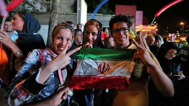 iranian women wave the national flag and flash the victory sign during celebrations in northern tehran after iran 039 s nuclear negotiating team struck a deal with world powers in vienna photo afp iranian women wave the national flag and flash the victory sign during celebrations in northern tehran after iran 039 s nuclear negotiating team struck a deal with world powers in vienna photo afp