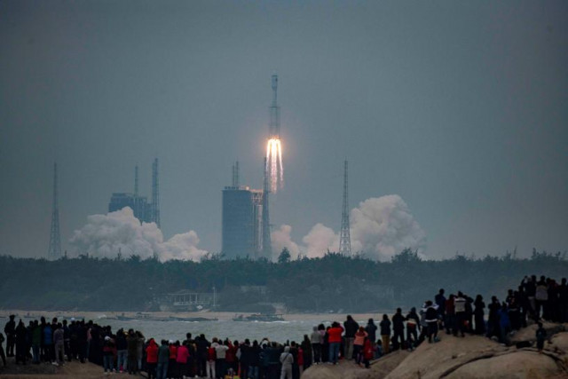 people watch the medium lift long march 8 y 1 rocket taking off from wenchang space launch center on a beach in wenchang hainan province china december 22 2020 photo reuters people watch the medium lift long march 8 y 1 rocket taking off from wenchang space launch center on a beach in wenchang hainan province china december 22 2020 photo reuters