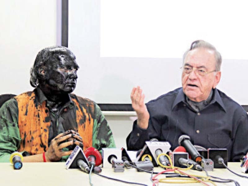 indian activist sudheendra kulkarni looks on as khurshid mahmud kasuri speaks to the media in mumbai photo afp