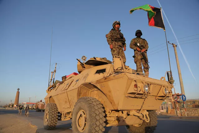 afghan security personnel stand guard on an armoured vehicle at a checkpoint in ghazni on october 13 2015 photo afp afghan security personnel stand guard on an armoured vehicle at a checkpoint in ghazni on october 13 2015 photo afp
