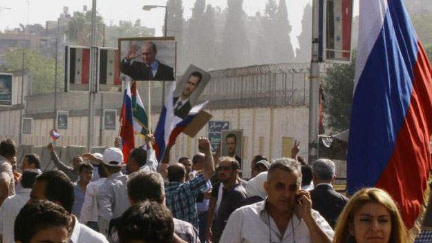 hundreds of people holding russian and syrian flags as well as portraits of the two countries 039 presidents gather near the russian embassy in damascus on october 13 2015 to express their support for moscow 039 s air war in syria photo afp