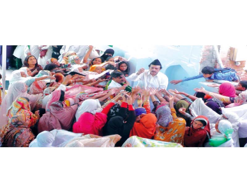 women devotees receiving langar from the custodian of the shrine photo express