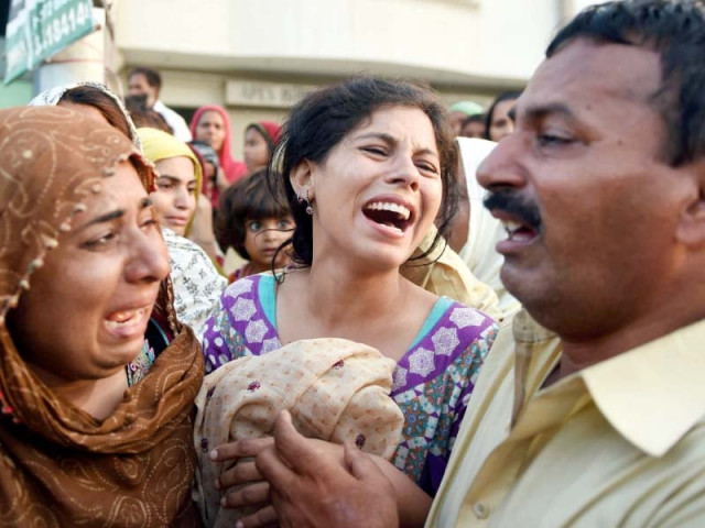 relatives mourn the death of their family members in a landslide in karachi photo afp relatives mourn the death of their family members in a landslide in karachi photo afp