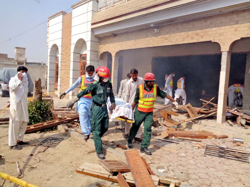 rescuers move a victim s body from the blast site in taunsa photo tariq ismaeel express